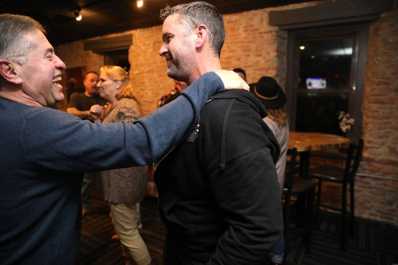 Kane County Sheriff incumbent Ron Hain (right) talks with former Kane County Sheriff Pat Perez as they await Election Night results at Bar Evolution in Batavia on Tuesday, Nov. 8, 2022.