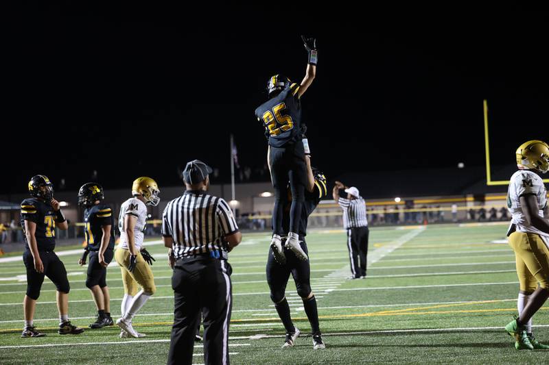 Herscher's Mason Roberts is hoisted in the air by teammate Gavin Hull after a touchdown during the Tigers 45-28 loss to Bishop McNamara on Friday, Sept. 5, 2025.