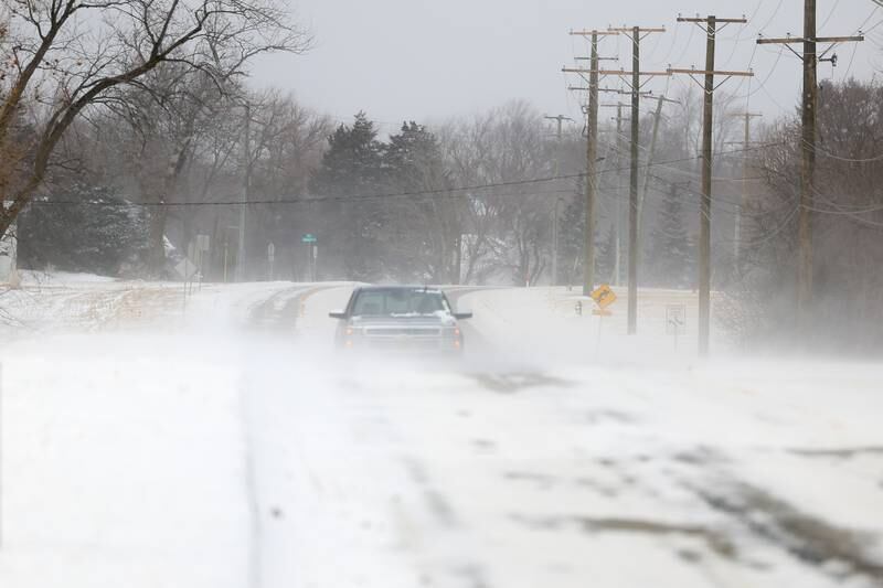 High winds blow snow across South Briggs Street in rural Joliet.