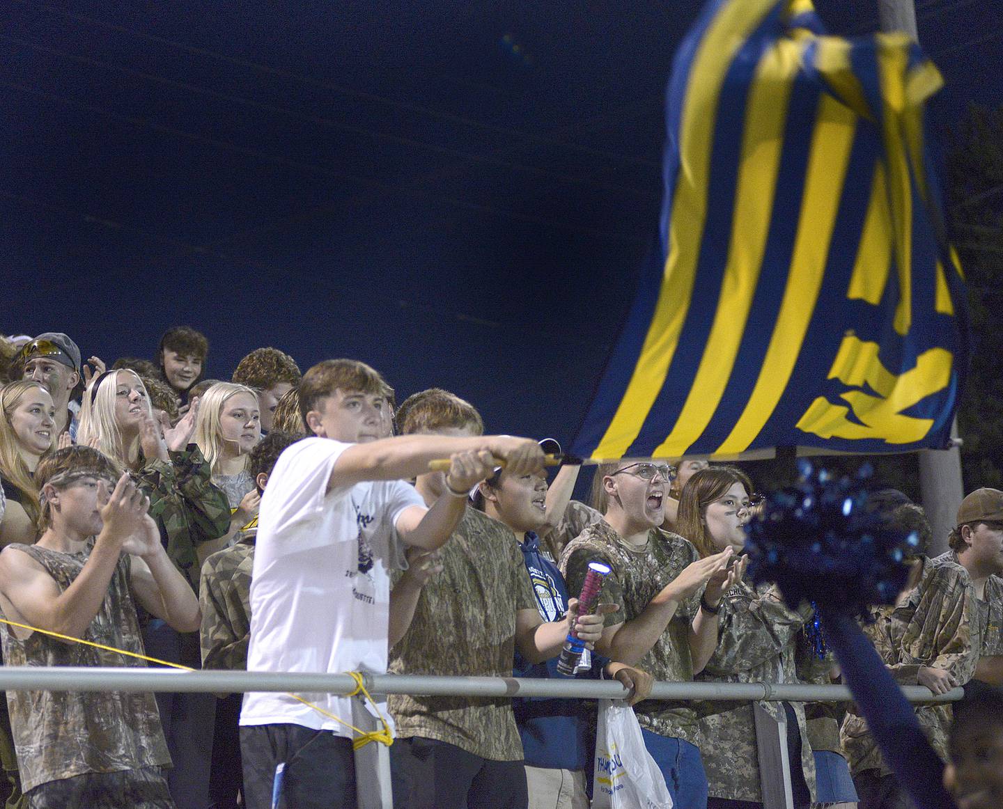 Marquette Crusader fans wave their flag after the Crusaders score against Seneca Friday at Marquette.