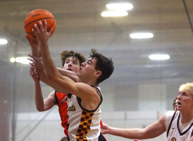 Richmond-Burton’s Dane Gardner, front, battles Crystal Lake Central’s Sonny Shanahan in varsity boys basketball E.C. Nichols tournament championship game action on Saturday, Dec. 27, 2025, at Homer “Bill” Barry Gymnasium on the campus of Marengo High School in Marengo.