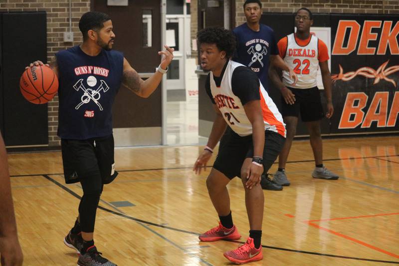 Ray Hernandez (left) dribbles the ball while calling for a screen to create space from his defender, Jalon Redmond Dec. 4, 2023 during the Guns and Hoses Basketball Game put on at Huntley Middle School in DeKalb.