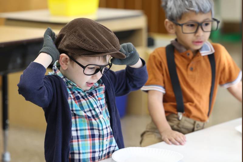 Shabbona Elementary School kindergartener Vernon Mohler adjusts his cap next to classmate Kyran Thurman, right, as they dressed up as 100 year olds during the 100th day of school on Monday, Feb. 9, 2026.