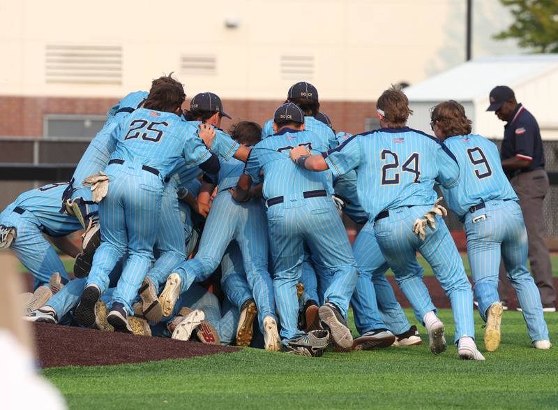 Marquette players celebrate Monday, June 2, 2025, after their Class 1A supersectional win over Fulton at Northern Illinois University in DeKalb.