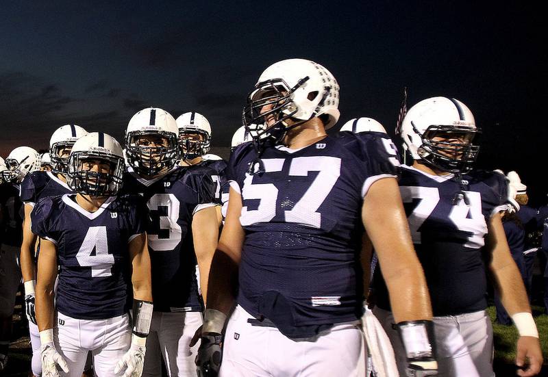 Cary-Grove Offensive Lineman Trevor Ruhland (57) waits on the sideline prior to the start of the game with Huntley on Friday, Sept. 26, 2014.