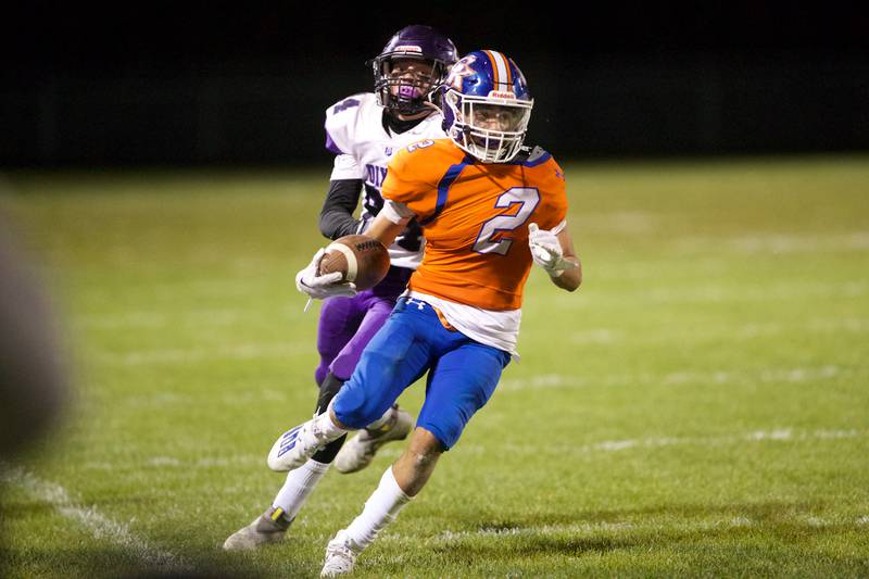 Genoa - Kingston's Traven Atterberry looks for runs for a gain as Dixon's Hunter Vacek looks for the tackle on Friday Oct.7,2022 in Genoa.