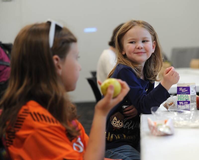 Janina Del Rosario, right, 5, of McHenry, talks with Jordyn Carpenter, 8, of McHenry, while they eat lunch Tuesday, June 7, 2022, at the McHenry Public Library, 809 Front St. in McHenry, during the library's free summer lunches for kids program.
