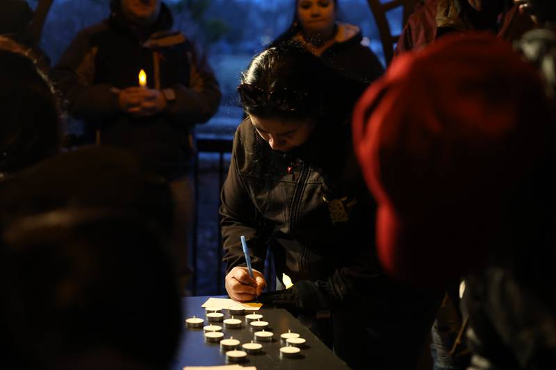 A woman shares words of encouragement for the family of the victims of the March 5th shooting at a candlelight vigil on Wednesday, March 8th, 2023 in Bolingbrook.