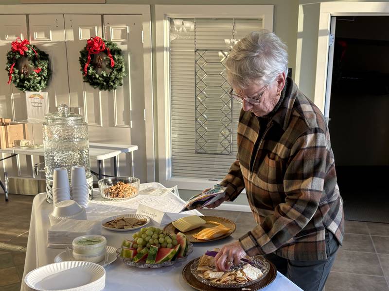 Adrienne Kalmes sets up refreshments before FaithBridge's Thanksgiving program Nov. 23, 2025 in Crystal Lake.