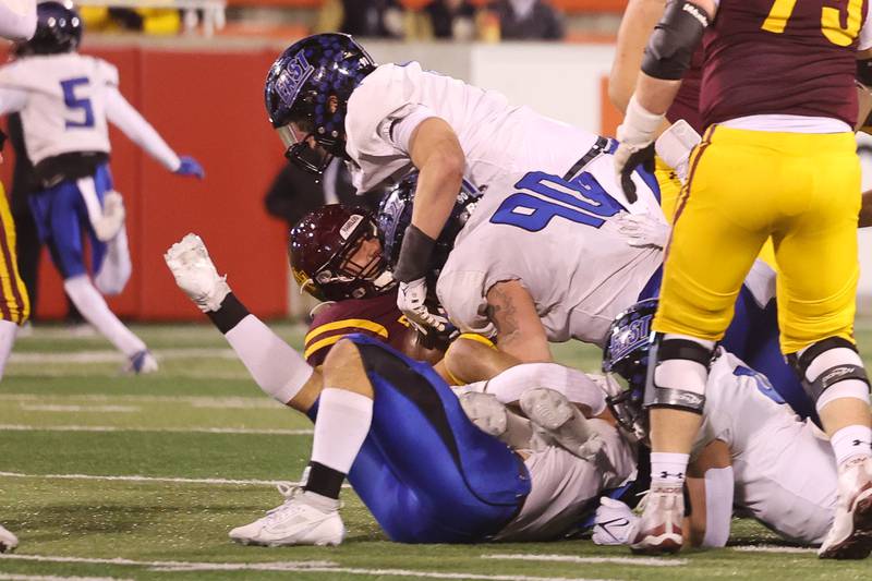 Lincoln-Way East’s Caden O’Rouke, top, takes down Loyola’s Ryan Fitzgerald for a turnover on downs in the Class 8A championship on Saturday, Nov. 25, 2023 at Hancock Stadium in Normal.