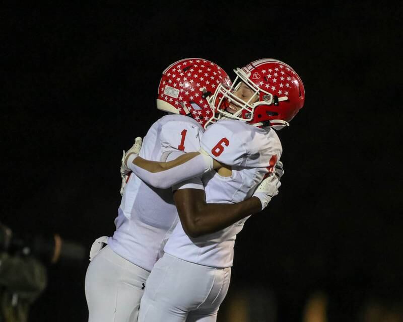 Naperville Central's DeShaun Williams (1) celebrates his second touchdown reception with teammate Dylan Martin (6) during Class 8A quarterfinal football game between Naperville Central at Lyons on Friday, Nov 15, 2024  in Western Springs.