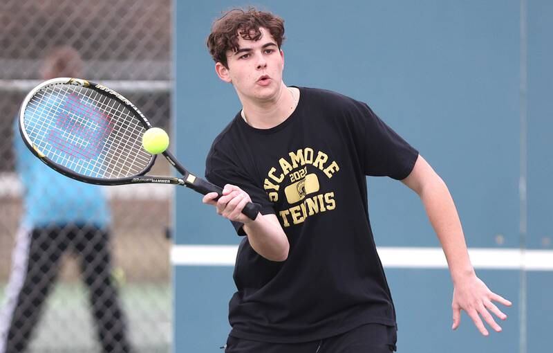 Sycamore’s Liam Kerbel hits a forehand during his number one doubles match along with partner Jonathan Locascio against Dixon Thursday, March 30, 2023, at Sycamore High School. This is the inaugural season for the Sycamore boys tennis team.