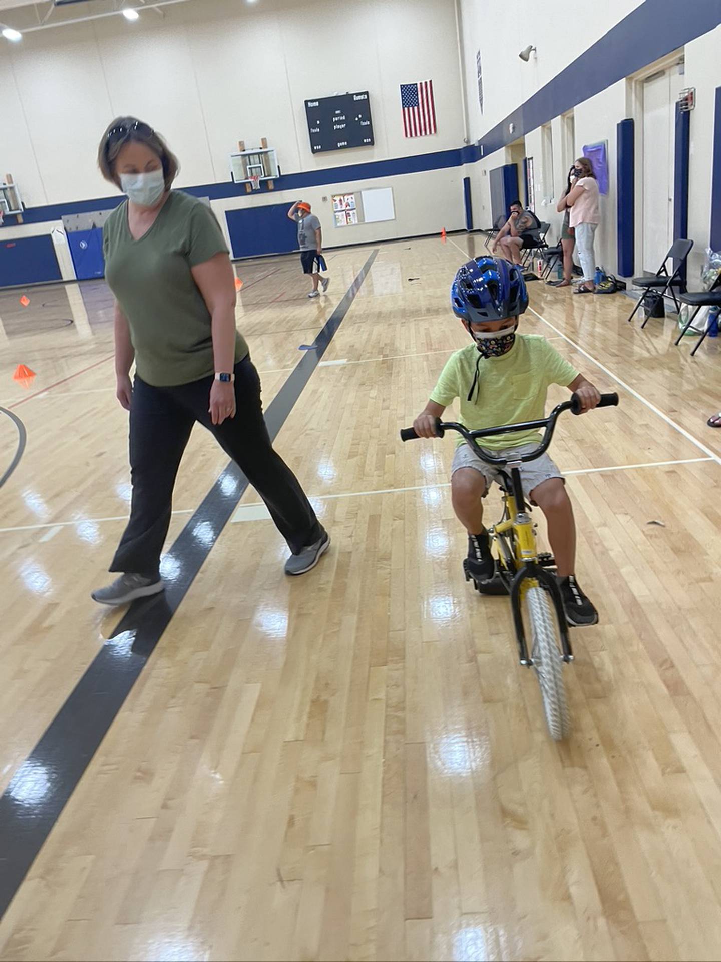 Brody Baumgardner practices the help of his bike skills under the watchful eye of volunteer Jana Ellison. The iCan Bike program, which teaches people with disabilities ages 8 and up to ride a conventional two-wheel bike, was held June 14 to June 18, 2021, at Spencer Crossing School in New Lenox.
