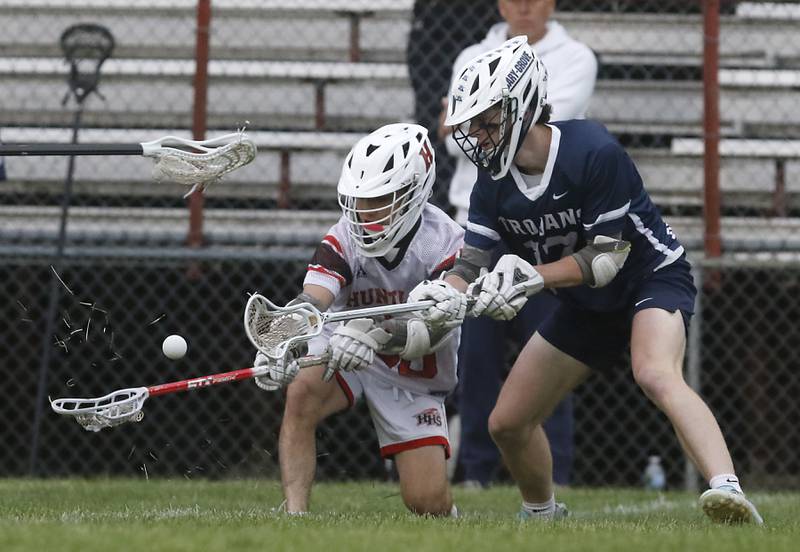 Huntley’s Cameron Abordo battles with Cary-Grove's Evan Lamb for the ball during the Marian Central Sectional boys lacrosse semifinal match on Wednesday, May 28, 2025, at Marian Central High School in Woodstock.