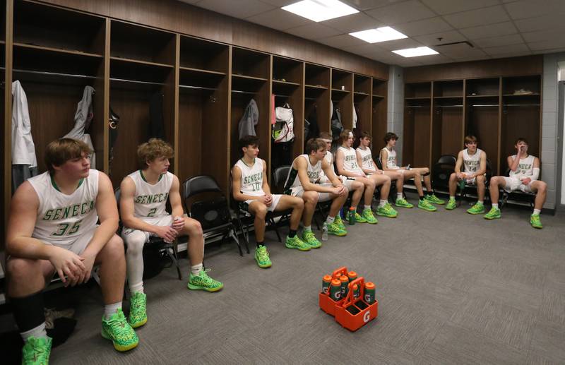 Members of the Seneca boys basketball team rest in the locker room while playing against Streator during a game on Tuesday, Dec. 21, 2023 at the United Center in Chicago.