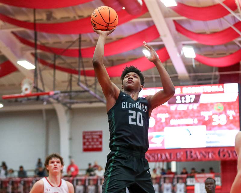 Glenbard West's Logan Glover (20) puts in a big shot during their basketball game between Glenbard West at Hinsdale Central, Friday  Dec 6, 2024  in Hinsdale.