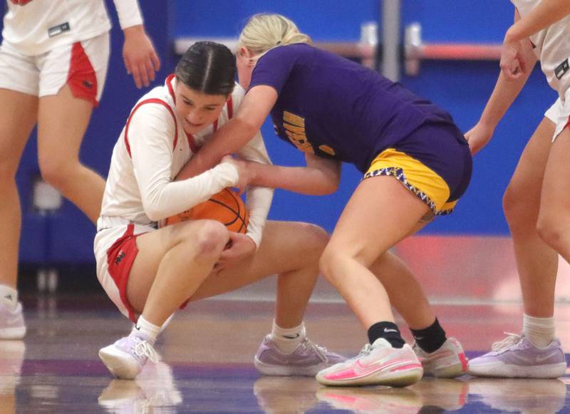 Huntley’s Aubrina Adamik, left, battles Hononegah’s Carly Koch for the ball in girls basketball at Dundee-Crown High School in Carpentersville on Tuesday, November 25, 2025.