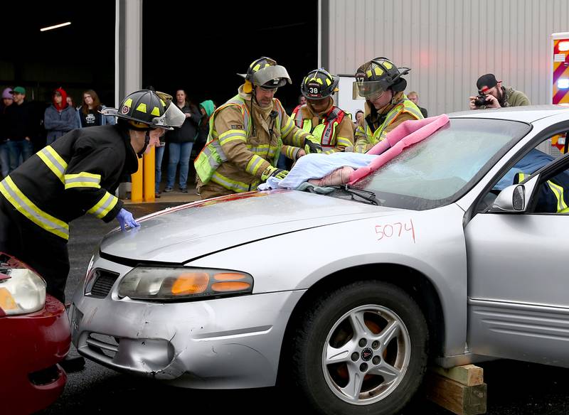 Leland and Sheridan firefighters and EMS tend to a patient that was thrown through a windshield during Mock Prom drill at Leland High School on Friday, May 6, 2022 in Leland.