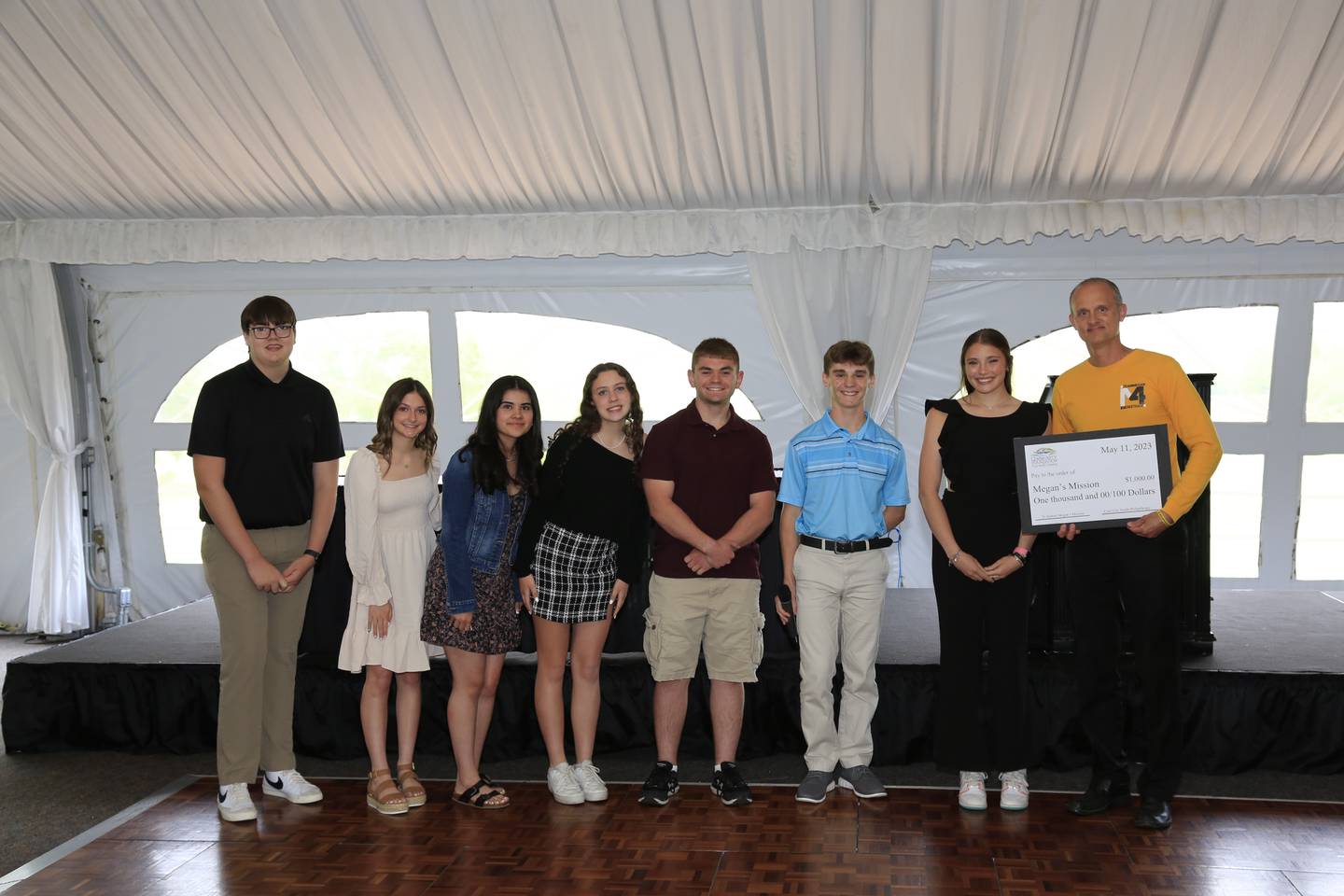 A representative from Megan's Mission accepts a donation from Coal City High School students.
