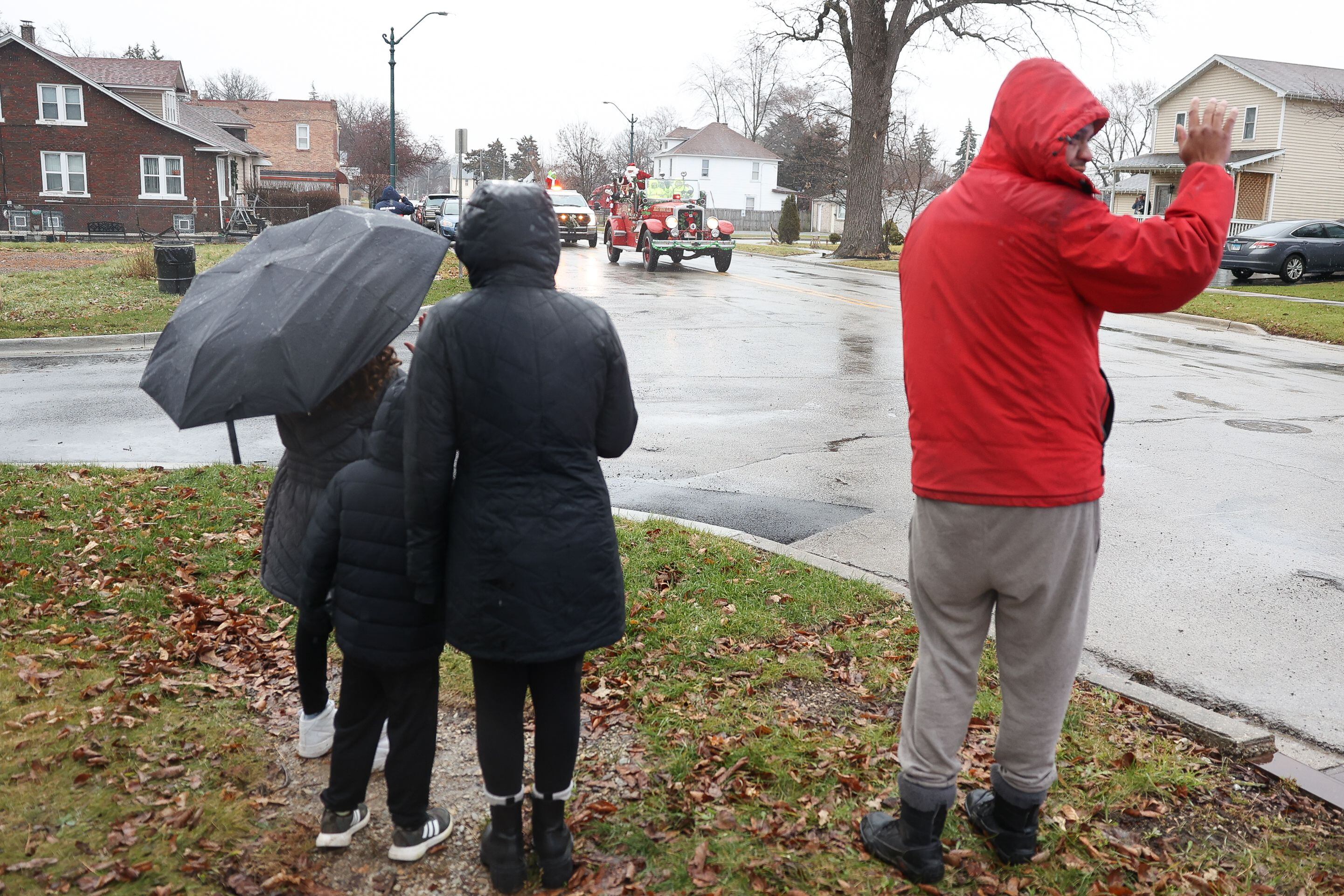 A family braves the rain to see Santa as he passes through Joliet on his way to the North Pole to get ready for Christmas Eve on Saturday, Dec.16th in Joliet.