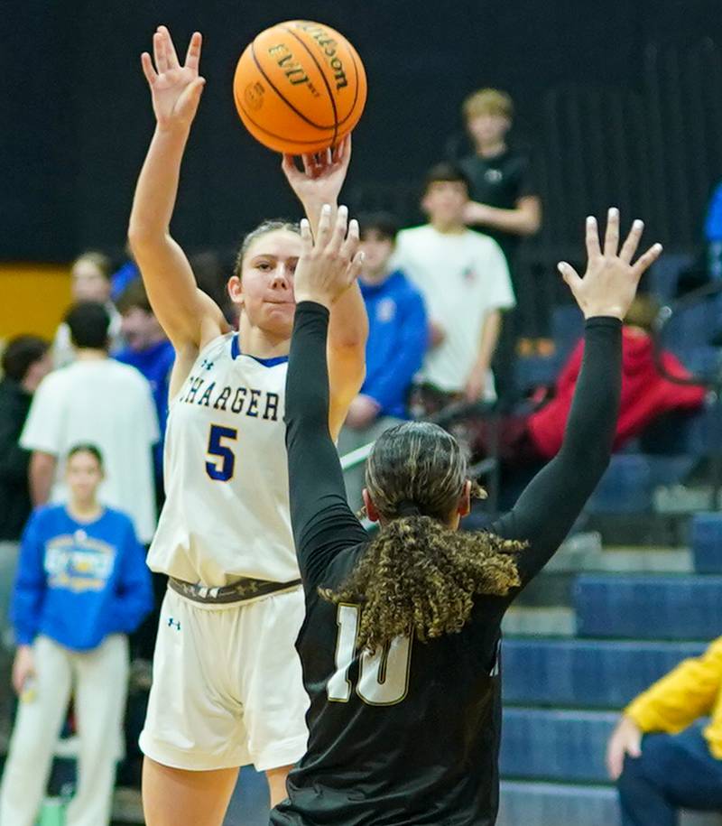 Aurora Central Catholic's Grace Grunloh (5) shoots a three pointer against Waubonsie Valley's Danyella Mporokoso (10) during a basketball game at Aurora Central Catholic High School on Thursday, January 30, 2025.