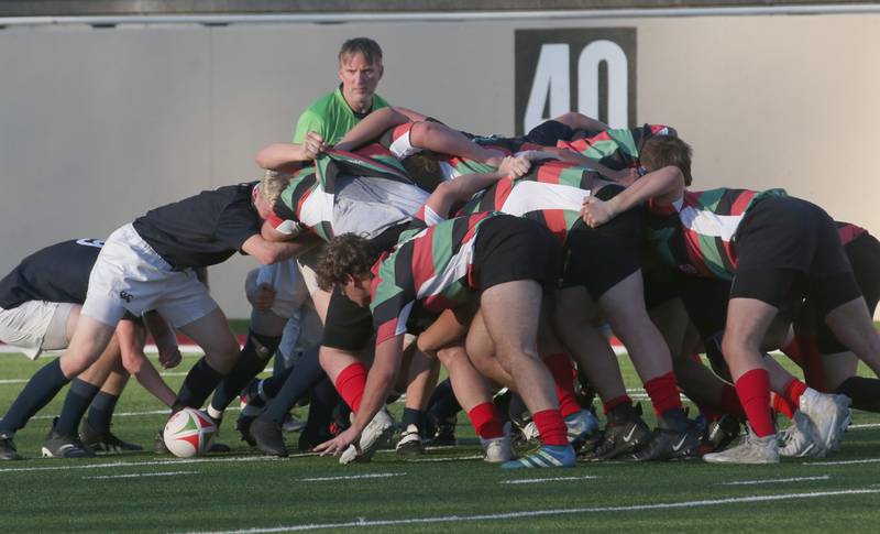 La Salle-Peru and La Salette Academy rugby teams battle during a scrum during a rugby game on Wednesday, April 12, 2023 at Howard Fellows Stadium at L-P High School. A Scrum or scrummage, is a method of restarting play in rugby football that involves players packing closely together to gain possession of the ball.