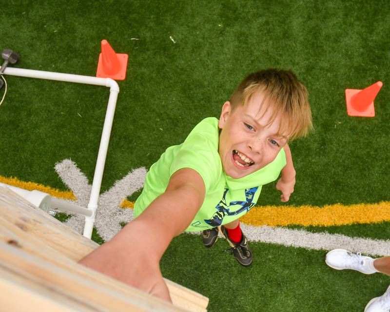 Nate Keeley of Downers Grove sees how high he can get in the standing vertical jump portion of the NFL Youth Flag Football Combine Day held at Doerhoefer Park in Downers Grove on Sunday Aug. 6, 2023.