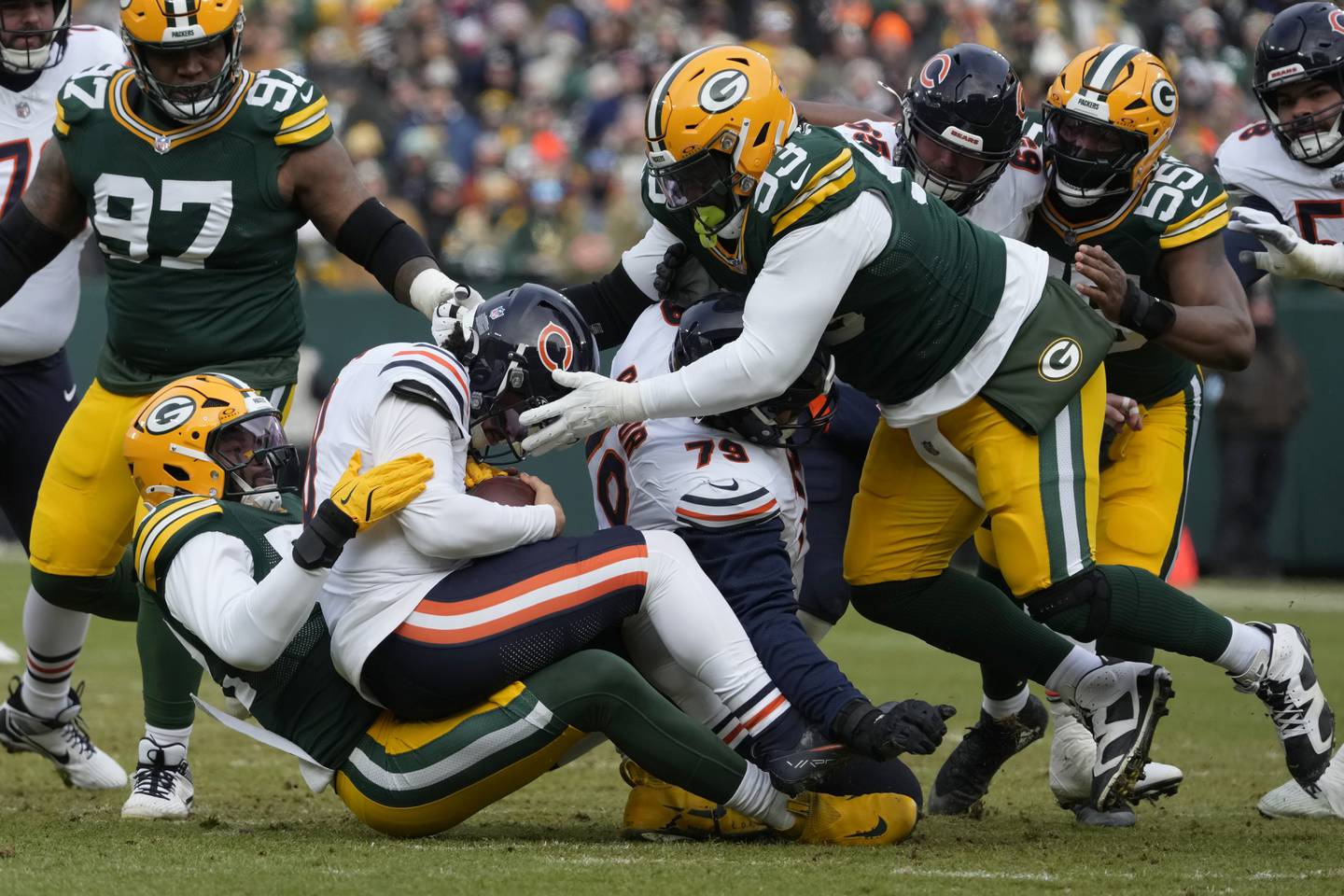 Green Bay Packers defensive end Rashan Gary, bottom left, tackles Chicago Bears quarterback Caleb Williams, middle left, during the first half of an NFL football game, Sunday, Jan. 5, 2025, in Green Bay, Wis. (AP Photo/Morry Gash)