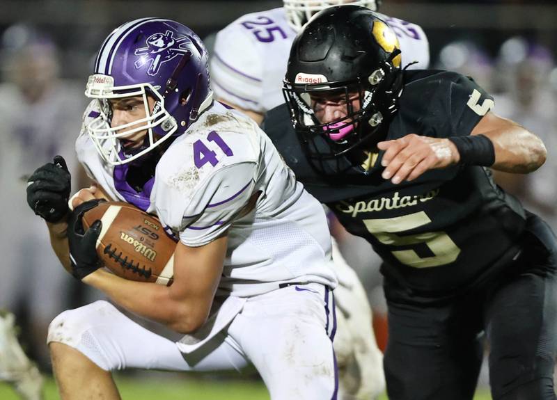 Sycamore's Kyle Prebil brings down Rochelle's Dylan Manning during their game Friday, Sept. 22, 2023, at Sycamore High School.