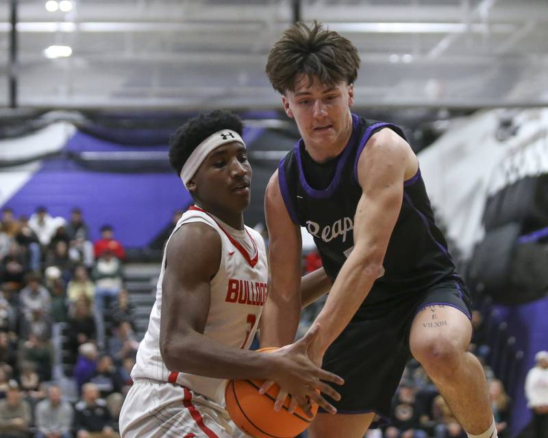 Plano's Ethan Taxis (3) gets tied up by Streator's Sharonn Morton (3) on a drive to the basket during their Plano Christmas Classic basketball game between Streator at Plano Friday, Dec 26, 2025 in Plano.