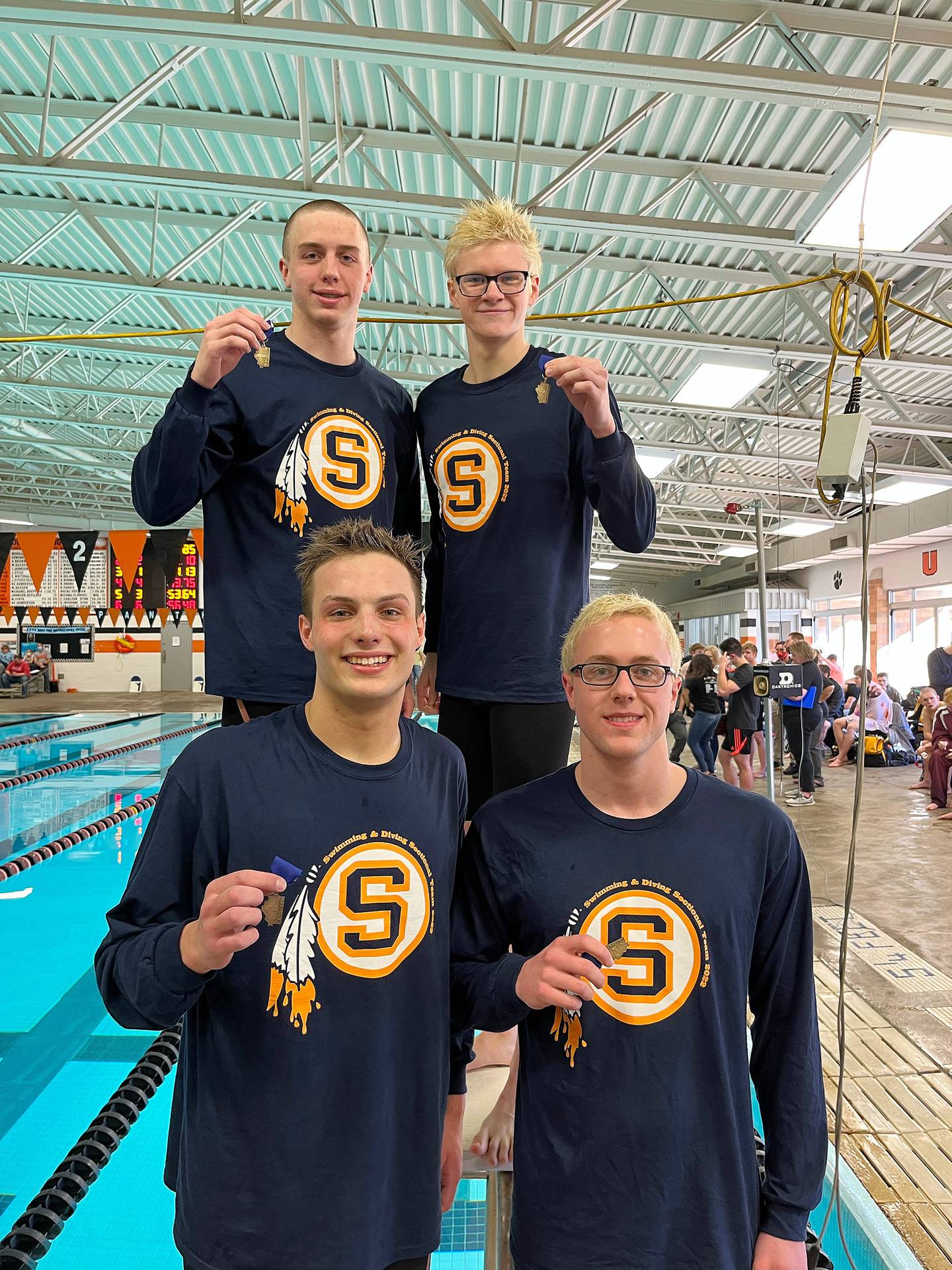 Sterling's 200 freestyle relay members pose with their medals after winning the race Saturday at the United Township Sectional in East Moline. The swimmers were (clockwise from top left) Skylar Drolema, Mason Adams, Michael Garland and Reiley Austin.