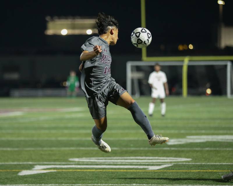 Morton's Caleb Mendoza (14) heads the ball during soccer match between Naperville North at Morton.  Sept 21, 2023.