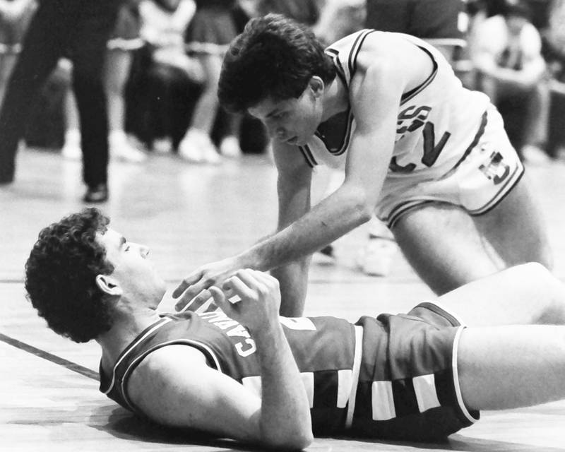 L-P's Tom Happ lays on the hardwood as Ottawa's Rick Hayne stand up after a foul during the Regional title game on Saturday, Feb. 28, 1986 at La Salle-Peru Township High School.