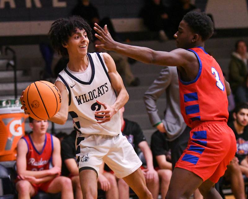 West Chicago's Jaxon Williams, left, passes the ball around Glenbard South's Ryan Hopkins (3) during the game on Friday Jan. 3, 2025, held at West Chicago High School.