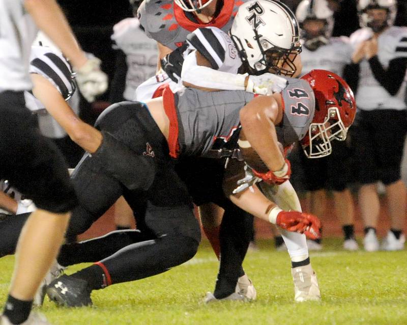 Yorkville's Jake Davies (44) powers for more yards after a catch against Plainfield defender Nigel Green (25) during the homecoming varsity football game at Yorkville High School on Friday, Sept. 23, 2022.