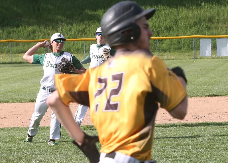 St. Bede's Nathan Husser throws across the infield to force out Putnam County's Cole Vipond on Tuesday, April 30, 2024 at St. Bede Academy.