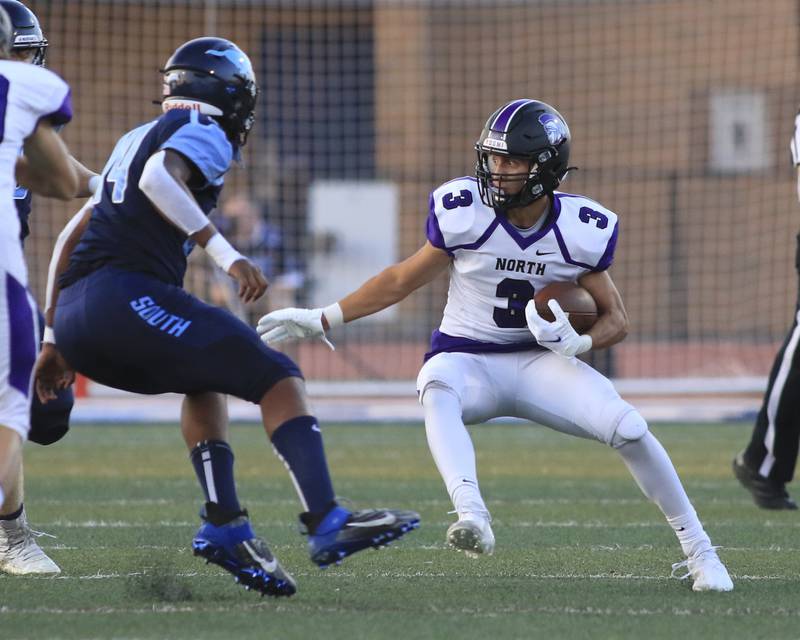 Downers Grove North's Ethan Thulin (3) avoids the Downers Grove South's defense during football game between Downers Grove North at Downers Grove South.  Sept 10, 2021.  Gary E Duncan Sr. for Shaw Local.