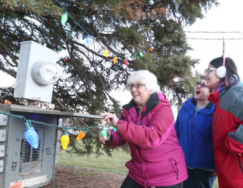 Michelle Rich, Horizon House CEO and Co-chairs Mellissa Lathrop and Bri Hrovat light the Tree of Hope on Wednesday, Dec. 13, 2023 at Horizon House in Peru. Over 75 percent of donations for this year have been met. An additional $12,640 is needed to reach the $60,000 goal. To donate to the Tree of Hope you can mail or drop off donations at Horizon House main office located at 2000 Plank Road in Peru.