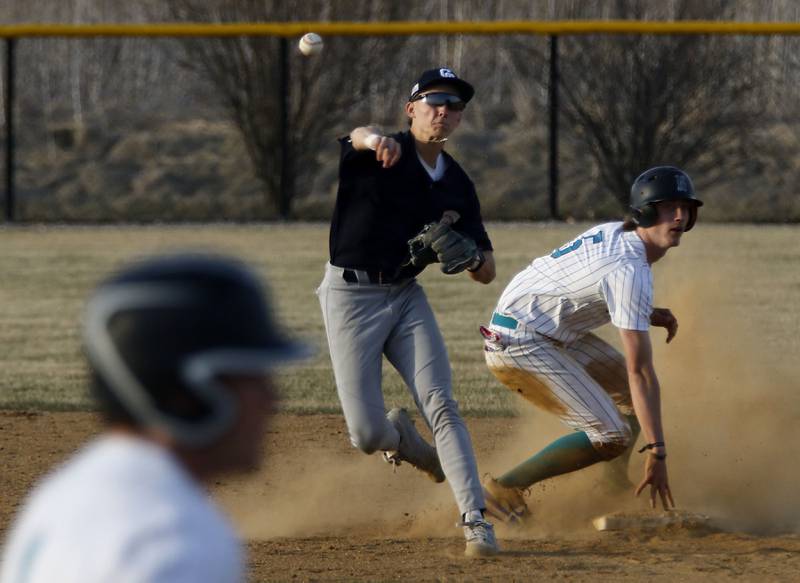 Cary-Grove's Francis Panko tries to turn a double play as Woodstock North's Tristan Schaffter slides into second base during a nonconference baseball game on Monday, March 30, 2026, at Woodstock North High School.