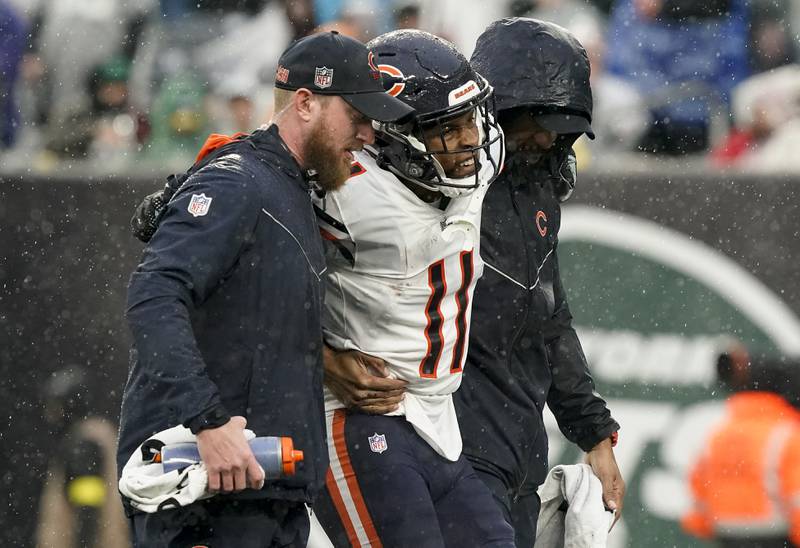 Chicago Bears wide receiver Darnell Mooney is helped off the field during the third quarter against the New York Jets , Sunday, Nov. 27, 2022, in East Rutherford, N.J.