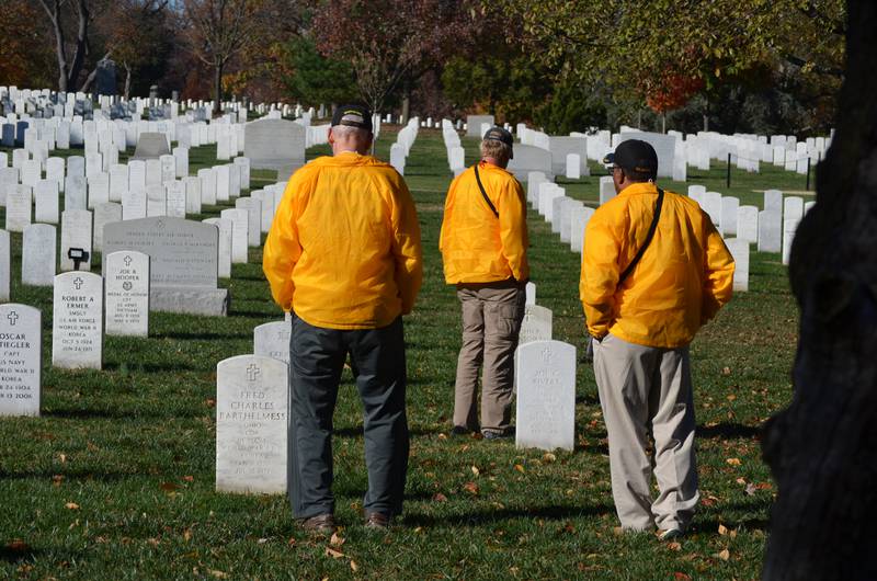 Members of the Whiteside County contingent of the Honor Flight of the Quad Cities stand in quiet observance at gravesites at Arlington National Cemetery on Tuesday, Nov. 8, 2022.