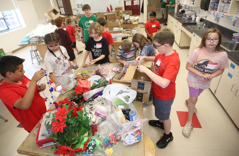 Studetns look through recycable materials during the Camp Invention on Wednesday, ?June 5, 2024 at Central Intermediate School in Ottawa. For over 30 years, the National Inventors Hall of Fame has inspired millions of chldren through it's flagship summer program. The weeklong program is led by qualified local educators in the Ottawa area along with local high schoolers volunteering. The camp is for students from kindergarten through sixth grades. Donations were made possible from Covia, US Silica, CAVIC, Financial Plus, Pilkington and community members. With the help of donations,  A total of 74 students were able to participate in this years camp.
