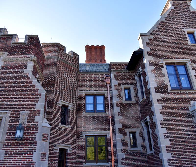 The massive, rebuilt chimneys and downspouts are displayed on the newly restored exterior of Mayslake Hall in Oak Brook.