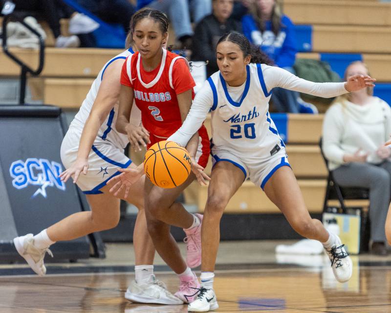 Batavia's Sidnee Justice  battles for the loose ball with St. Charles North's Sydney Johnson on Friday, Dec.12,2025 in st. Charles.