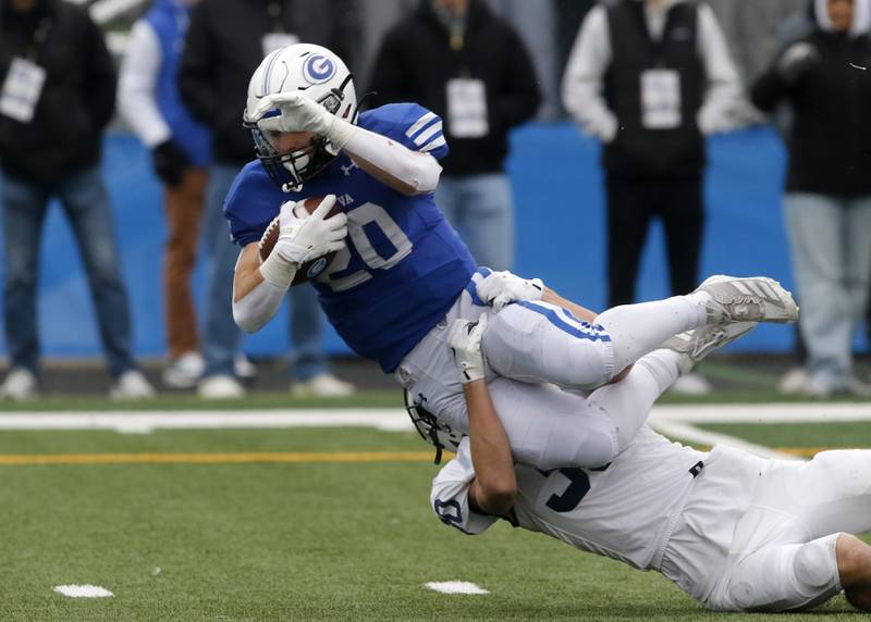 Cary-Grove's Ty Drayton tackles Geneva’s Michael Rumoro during an IHSA Class 6A semifinal football game on Saturday, Nov. 23, 2024, at Geneva High School.