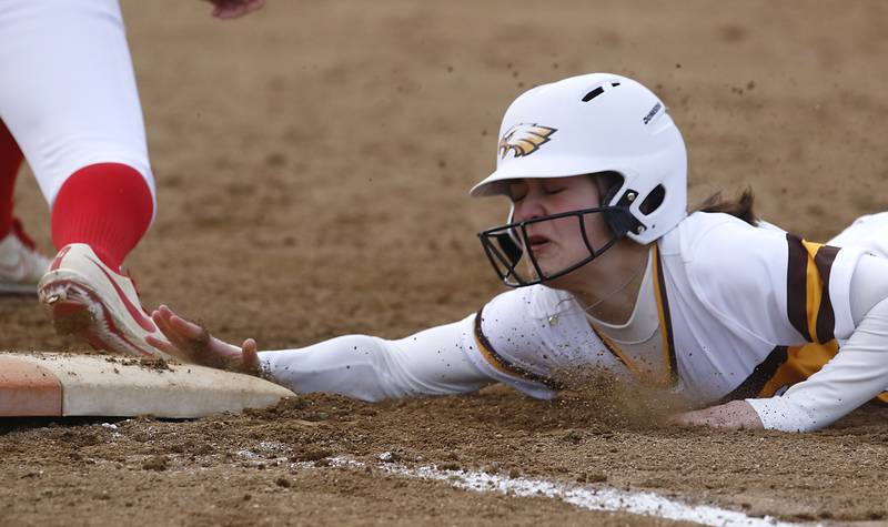 Jacobs’ Clare Piazza tries to get back to first base after a fly ball was caught during a non-conference softball game against Palatine Monday, March 20, 2023, at Palatine High School.