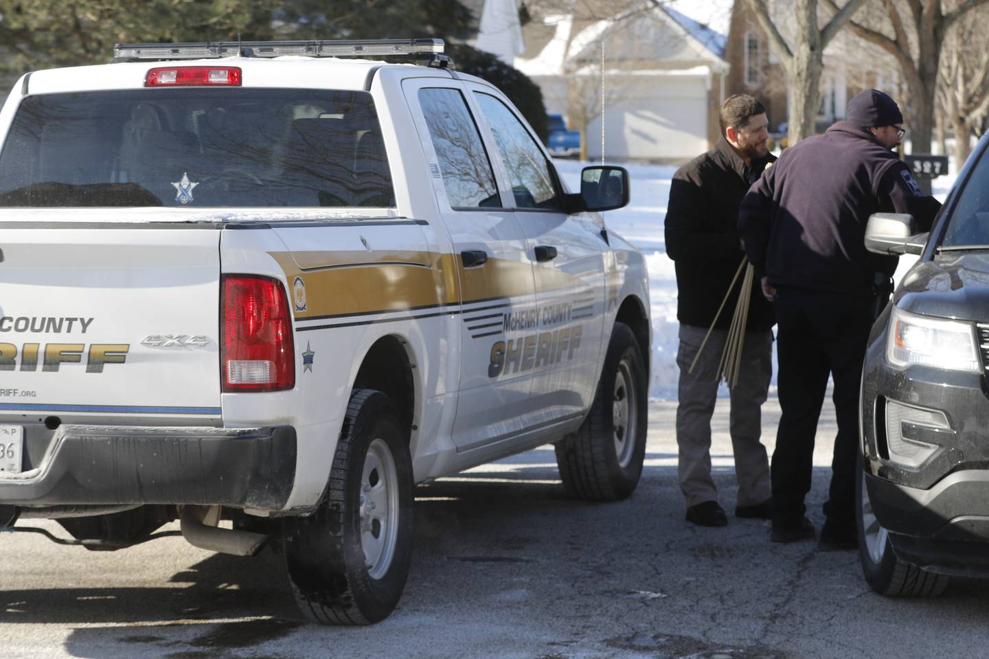 Investigators from multiple law enforcement agencies were probing the scene outside a Manchester Lane home in the River Walk of Port Barrington neighborhood on Tuesday, Jan. 11, 2022, after McHenry County sheriff's deputies shot and killed a person who allegedly opened gunfire on a woman and deputies in the early morning hours.