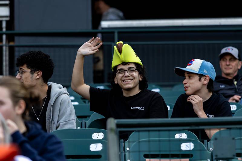 Lockport Township High School band member Justin Ramirez waves during the home opener of the Joliet Slammers on Friday, May 8, 2026.