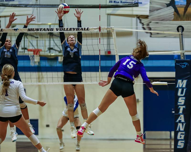 Downers Grove North's Cailyn Myers (15) watches her kill attempt get past the defense during volleyball match between Downers Grove North at Downers Grove South.  Sept 7, 2023.