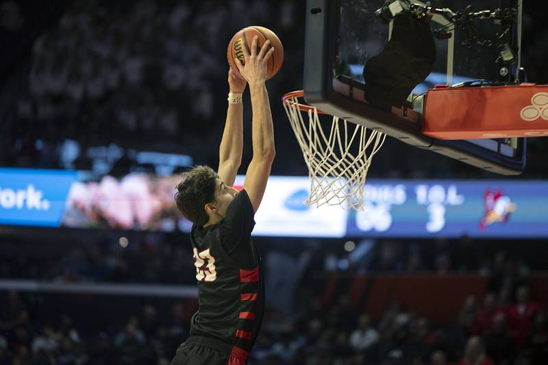 Benet Academy’s Niko Abusara goes up for a late game dunk against New Trier Friday March 10, 2023 during the 4A IHSA Boys Basketball semifinals.
